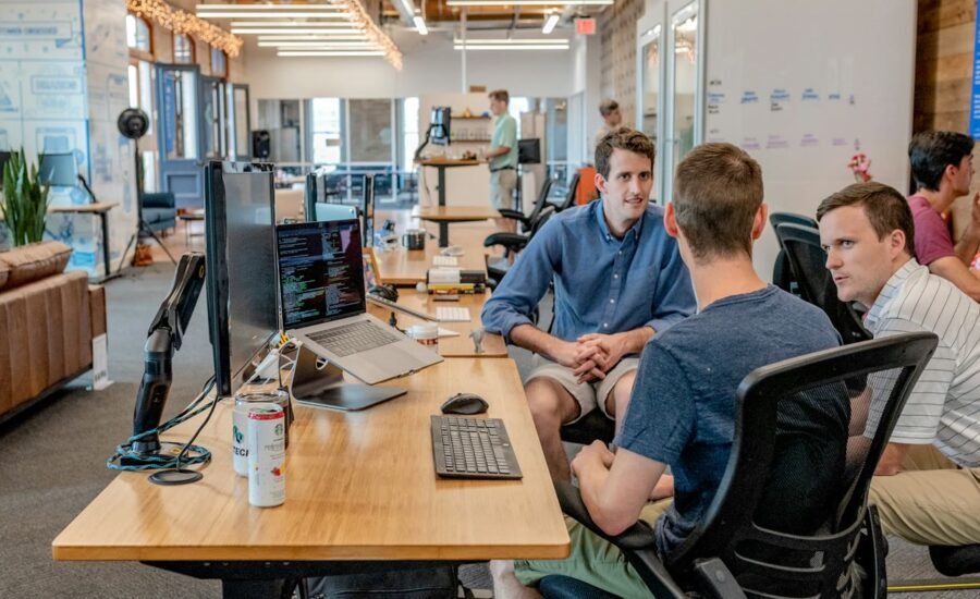 Support and operations team collaborating at computers, representing AI ticket triage and routing workflows