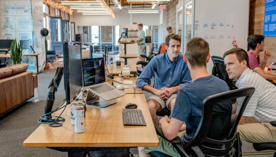 Support and operations team collaborating at computers, representing AI ticket triage and routing workflows